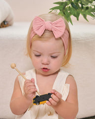Jollybows baby headband with elastic band provides snug, non-slip fit.
