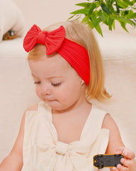 Jollybows white headband with bow pairs with any outfit for Christmas.