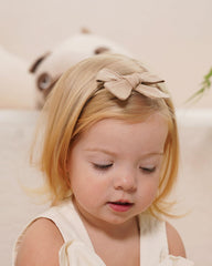 Jollybows bows on baby hair demonstrating comfortable elastic fit.