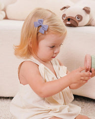 Jollybows mini bow 2in sand complements outfits while staying lightweight.