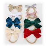 Jomila 8pcs velvet bow headbands showcase versatile styles for coordinated baby outfits and all-day wear comfort.