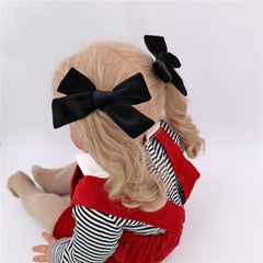 Jomila velvet bow hair clip worn on toddler for everyday charm.