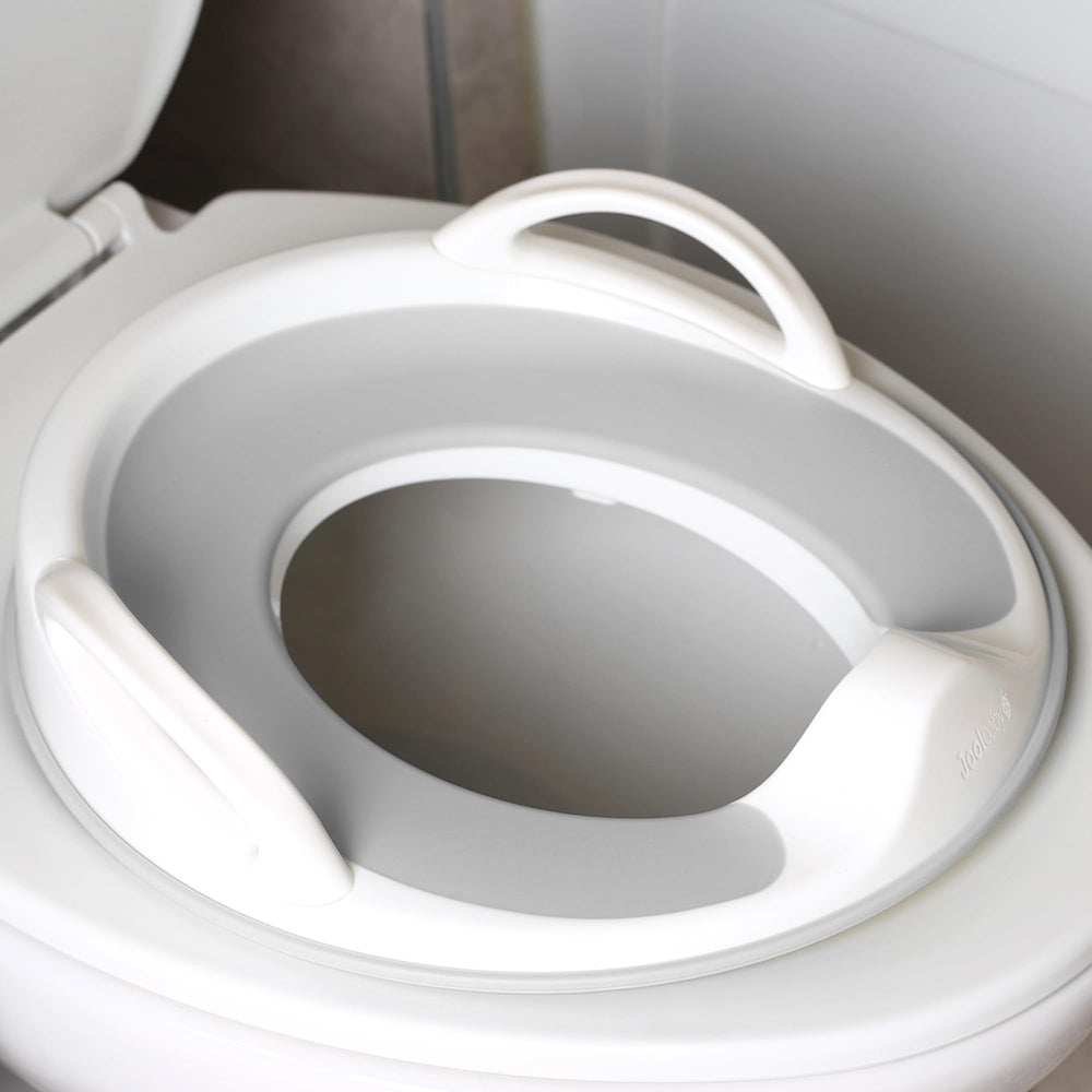 Jool Baby potty seat handles provide secure grip for confident sits.
