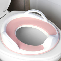 Jool Baby pink potty seat with handles providing secure grip for toddlers