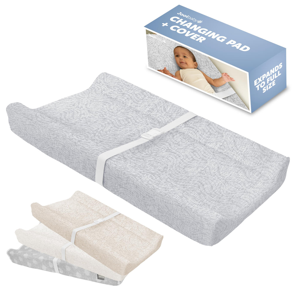 Jool Baby Serenity changing pad on a dresser with the gray wave pattern for diaper changes.