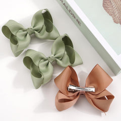 Handmade JOYOYO bows in multiple colors for versatile outfits.
