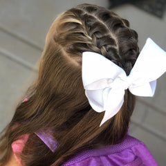 JUCCPUL white 6-inch bow on a girl, showcasing back-to-school style.
