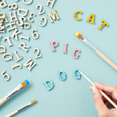Close-up of Juvale 1-inch wooden letters showing unfinished natural wood texture
