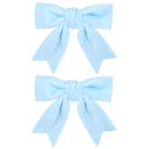 KCHIES 3in velvet bow light blue clipped on hair for secure all-day wear.