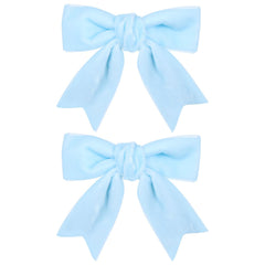 KCHIES 3in velvet bow light blue clipped on hair for secure all-day wear.