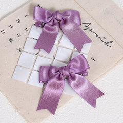 KCHIES purple glitter satin bow clip, side view, secure grip for thick or fine hair