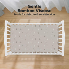 KeaBabies Isla fitted crib sheet demonstrates SnugFit Tech for easy on and off.