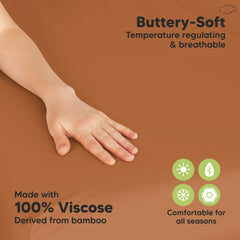 KeaBabies rust mini crib sheet close-up highlighting soft, skin-friendly fabric.