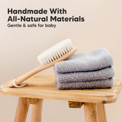 KeaBabies wooden hair brush handle closeup showing walnut oval grip.