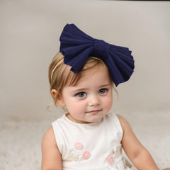 Kenjudess stretchy nylon headband closeup shows large bow for easy styling.