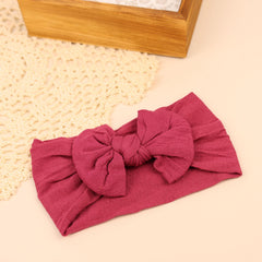 Kenjudess oversized bow headband closeup highlights bold knot for photo-ready outfits.