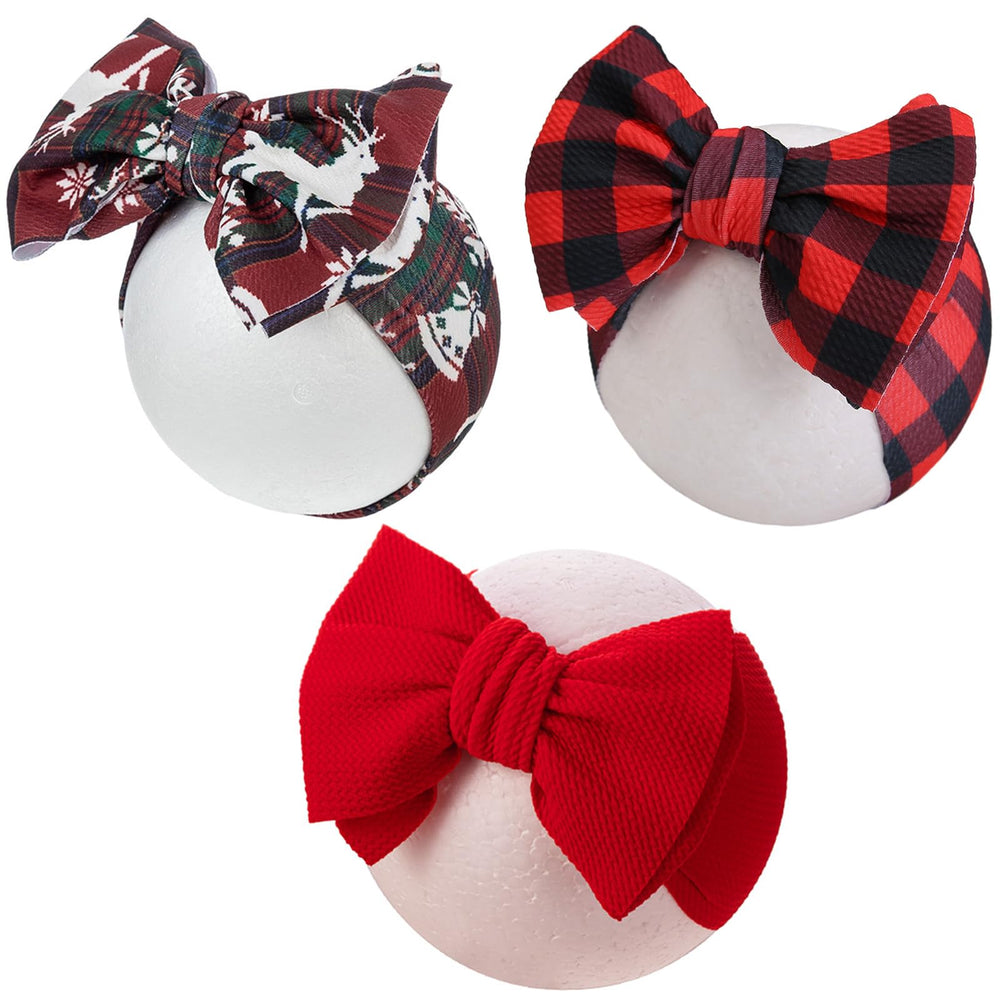 KIDOCHEESE Christmas baby bows front view; soft, adjustable headband for newborns.