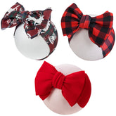 KIDOCHEESE Christmas baby bows front view; soft, adjustable headband for newborns.