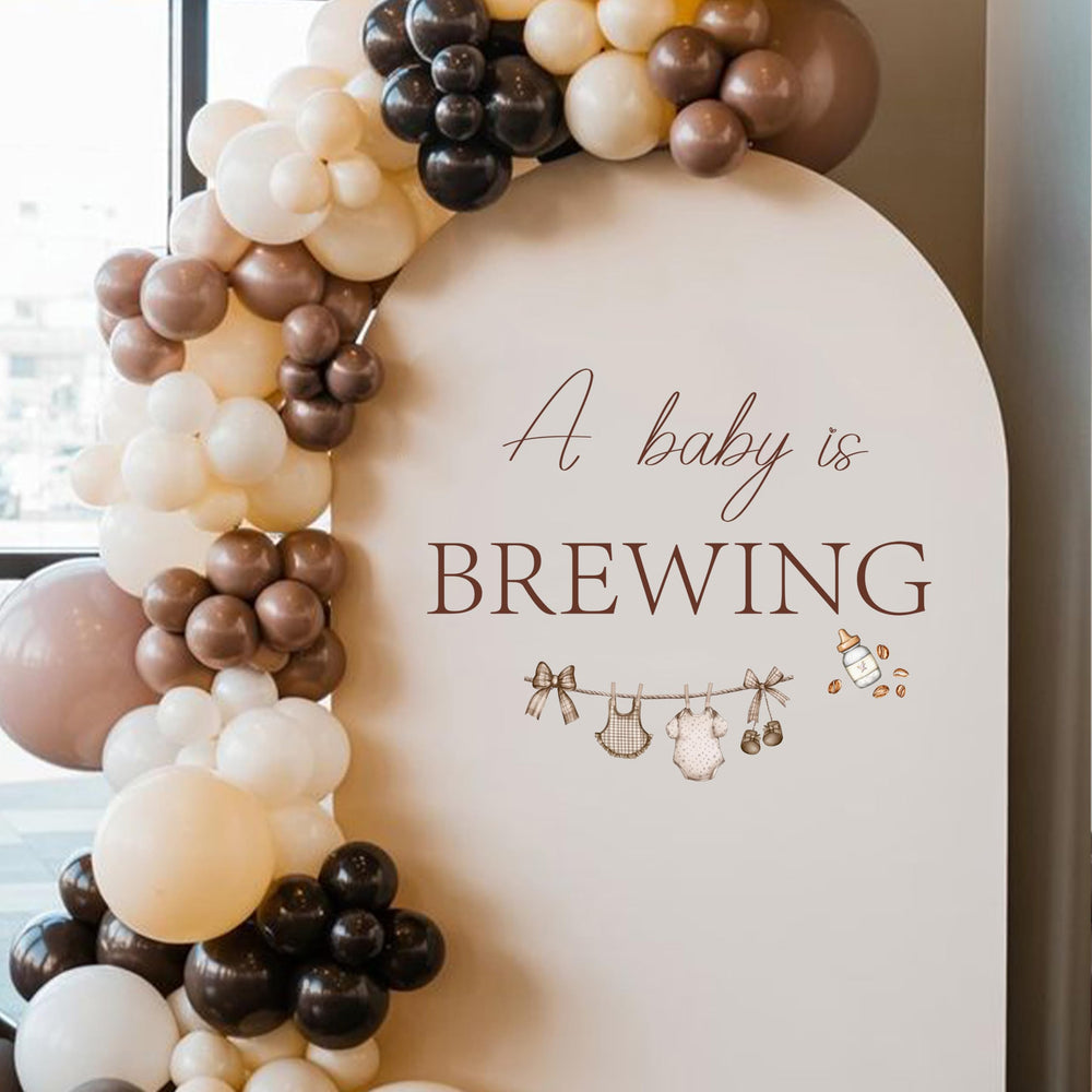 KIETKIE A Baby is Brewing wall decal features coffee cups for a warm baby shower backdrop