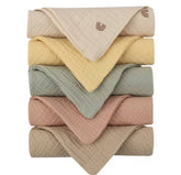 Kjuti Organic Muslin Burp Cloths close-up shows ultra-soft 4-layer weave for absorption.
