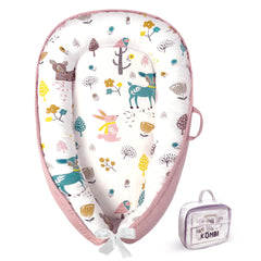Kombi Baby Lounger Nest pink front view showing cozy newborn support and surround bumpers.