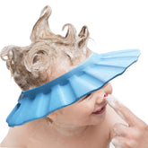 KOMIDK soft adjustable baby shower cap in blue protects eyes during bath time.
