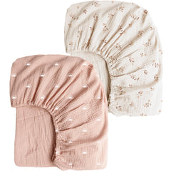 Konssy muslin crib sheet in pink sun offers breathable comfort for baby naps.