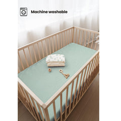 Konssy crib sheets leaf-green prints brighten the nursery.