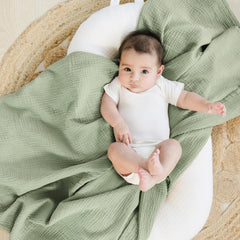 Konssy muslin swaddle blankets flatlay in woodland-sage with soothing unisex tones and texture.