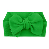 Koolgil baby headband in green with a big bow for cute photos and party looks.