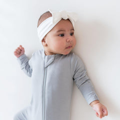 KYTE BABY bamboo bow adjustable tie demonstrates secure fit for growth.