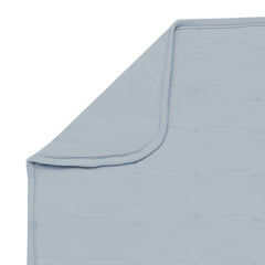 KYTE BABY Fog blanket closeup texture emphasizes plush softness against delicate baby skin.