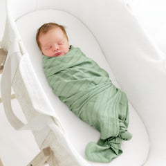 KYTE BABY rayon muslin swaddle with woven stripe detail for versatile use