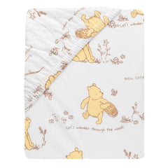 Lambs & Ivy Disney Baby Storytime Pooh sheet elastic edge securing crib fit.