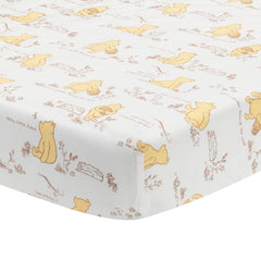 Lambs & Ivy Disney Baby Storytime Pooh sheet on crib mattress for breathable comfort.