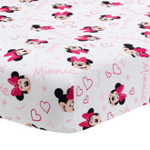 Lambs & Ivy Minnie Love crib sheet closeup showing Minnie heads and pink hearts for nursery decor.