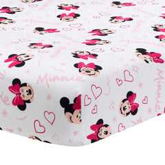 Lambs & Ivy Minnie Love crib sheet closeup showing Minnie heads and pink hearts for nursery decor.