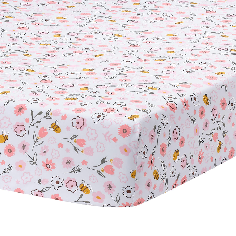 Lambs and Ivy Little Garden Sheet folded, pink floral fabric, soft breathable cotton for crib comfort.