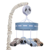 Lambs & Ivy Little Racer velour cars swirl above crib for gentle visual stimulation.