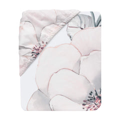 Lambs & Ivy Signature Botanical Baby Watercolor Crib Sheet on mattress shows secure elastic fit for standard crib.