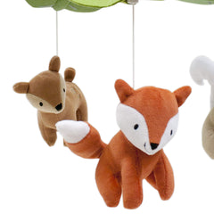 Lambs & Ivy Woodland Tales mobile near baby's crib playing Brahms' Lullaby for soothing sleep.