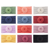 Lawie donut top-knot headband yellow offers soft, stretchy nylon for gentle daily wear