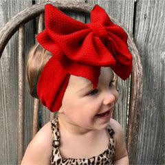 LDDCX red baby bows headband side view, comfortable stretch for 0-3 years.