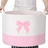 LemonRoad Pink Bow Extra Large Basket full of blankets for easy living room organization.