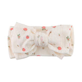 LemonSpace knotted double bows strawberry-print headband on newborn for everyday outfits.