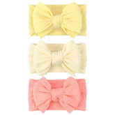 LemonSpace baby bow light yellow close-up showing soft stretch for gentle wear.