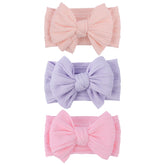 LemonSpace handmade headband bow closeup shows soft fabric for gentle baby comfort.