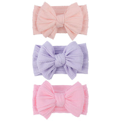 LemonSpace handmade headband bow closeup shows soft fabric for gentle baby comfort.