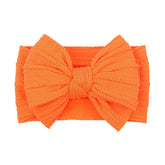 LemonSpace orange baby bow packaged for gifting and display