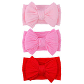 LemonSpace red baby bow headband front view shows soft stretch nylon for all-day comfort.